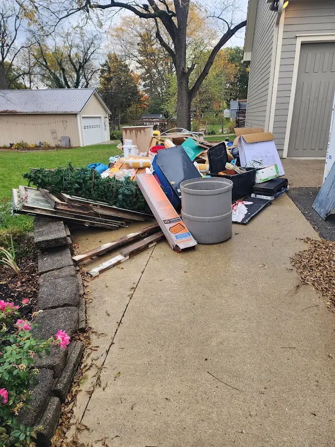 Dumpster being loaded with debris for 3 Yard Dumpster Rental in Greentown